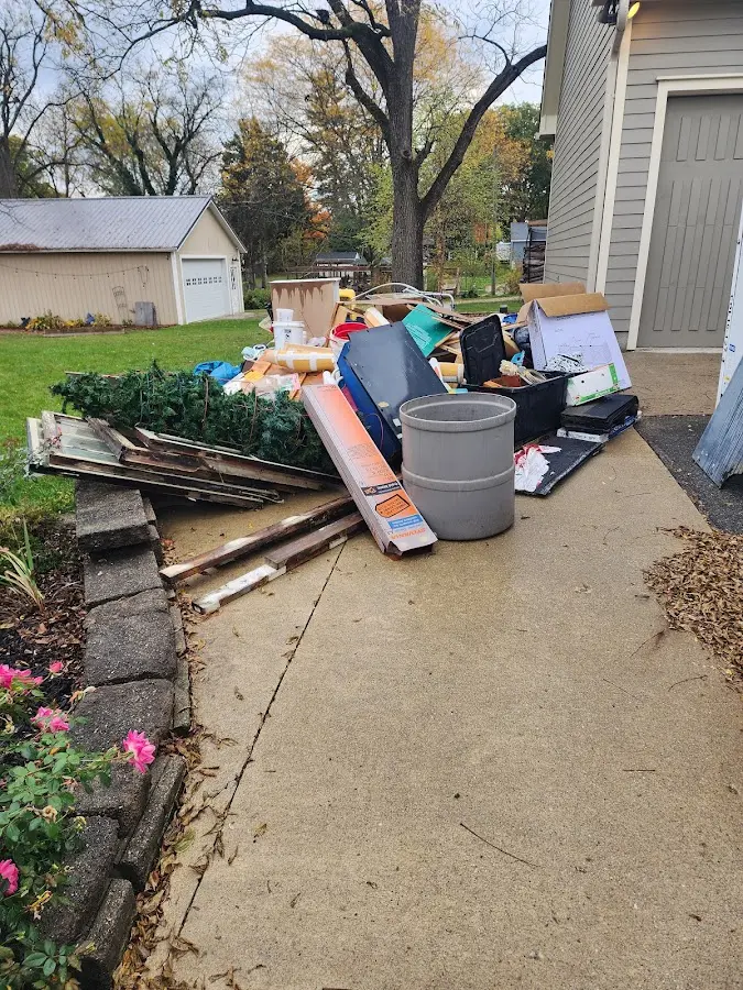 Dumpster being loaded with debris for 12 Yard Dumpster Rental in Whitney